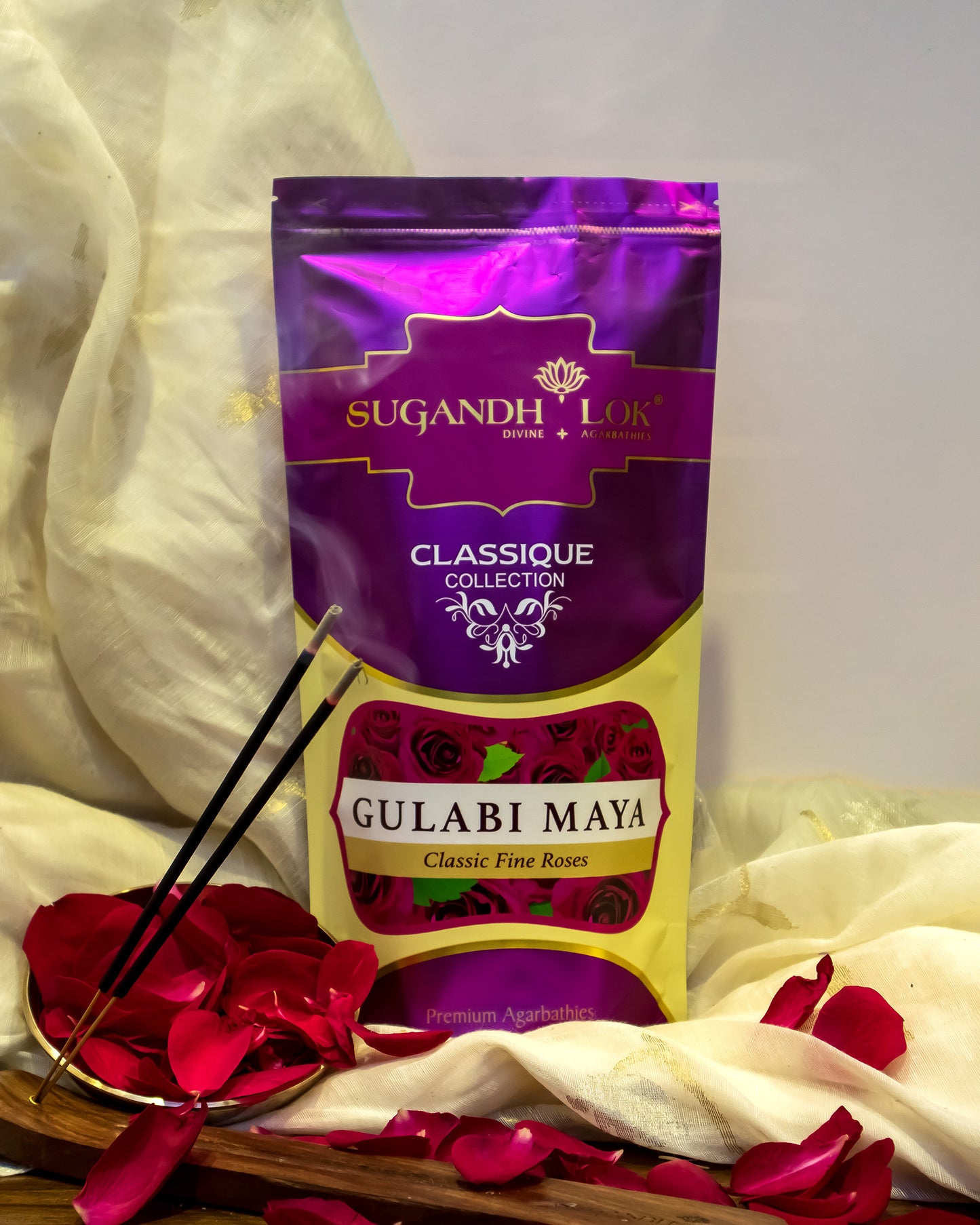 Front of Gulabi Maya Agarbatti Pouch surrounded by petals