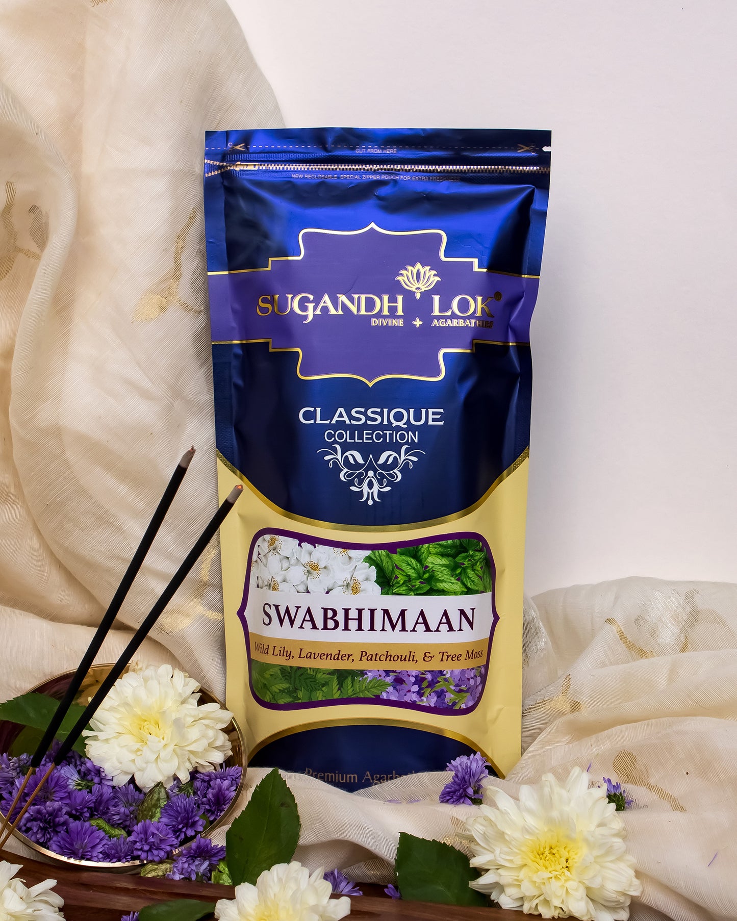 Front of Swabhimaan Agarbatti Pouch placed on a table surrounded by flowers
