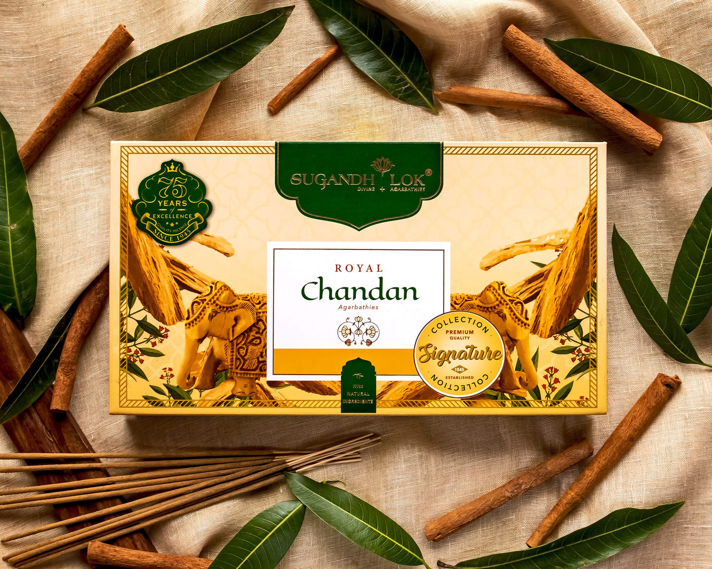 Royal Chandan Agarbatti Box surrounded by sandalwood sticks and leaves