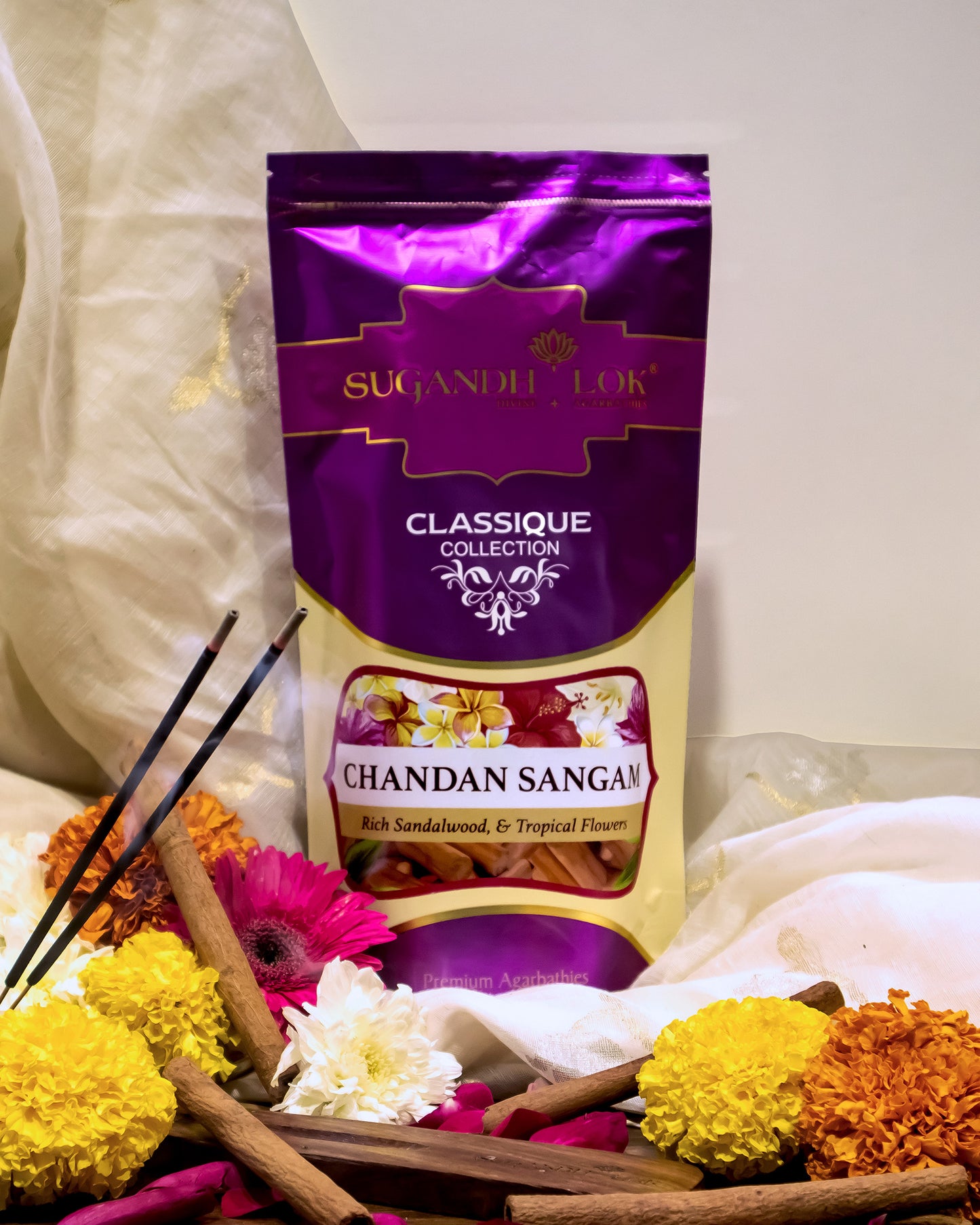 Chandan Sangam Agarbatti Pouch surrounded by flowers and chandan