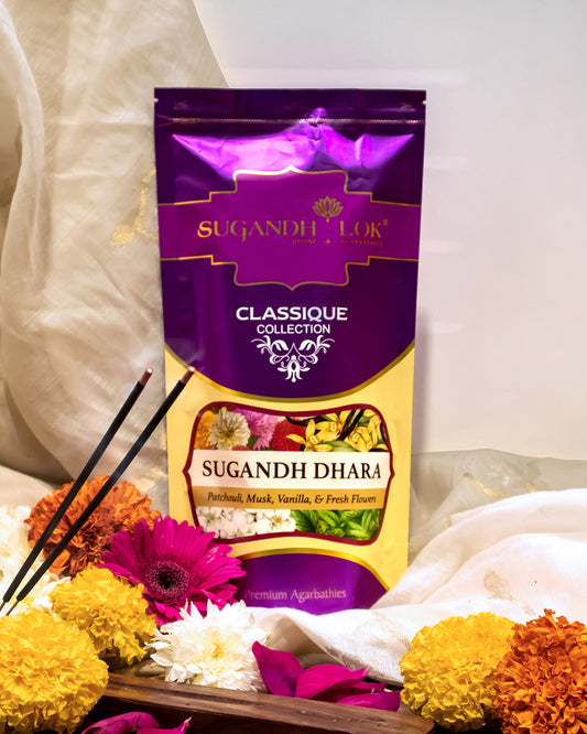 Front of Sugandh Dhara Agarbatti Pouch surrounded by flowers placed on a table