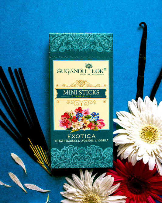 Front of Exotica Agarbatti Mini Sticks Pack surrounded by flowers and incense sticks