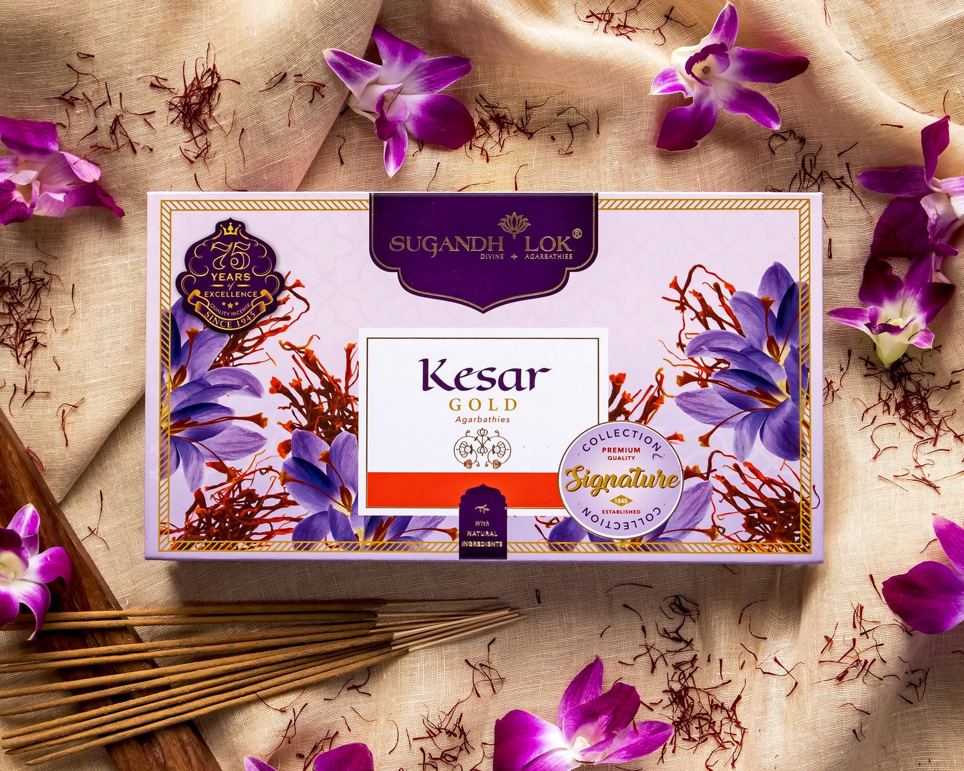 Front of Kesar Gold Agarbatti Box surrounded by kesar flowers